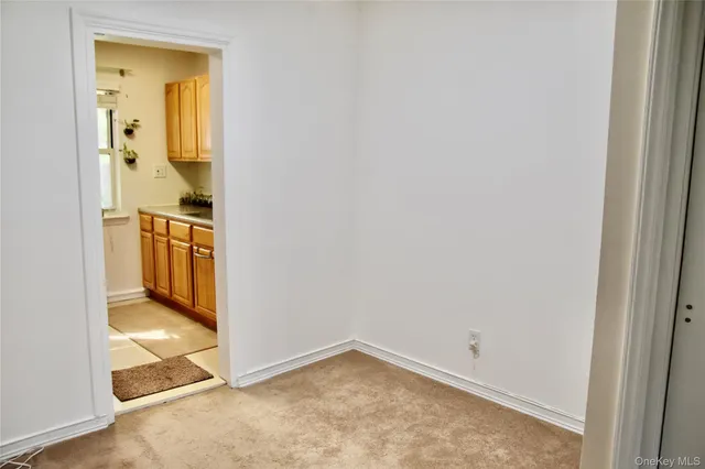 an empty room with a bathroom and a sink