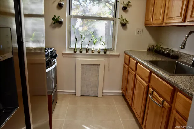 a kitchen with a sink and a refrigerator
