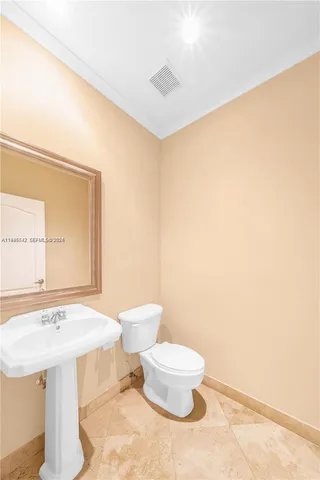 a bathroom with a sink a toilet and mirror