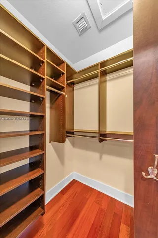 a view of walk in closet with empty racks