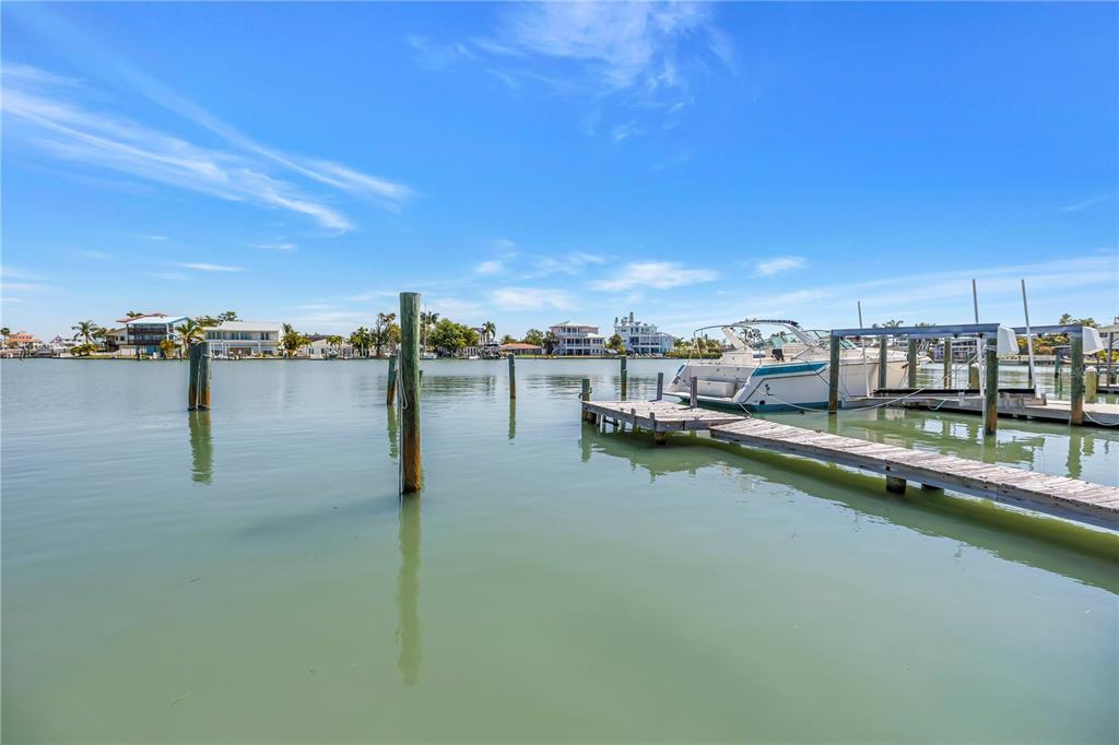 14045 East Parsley Drive Madeira Beach, FL 33708 - Photo 4 of 14 a view of a lake with boats and trees in the background