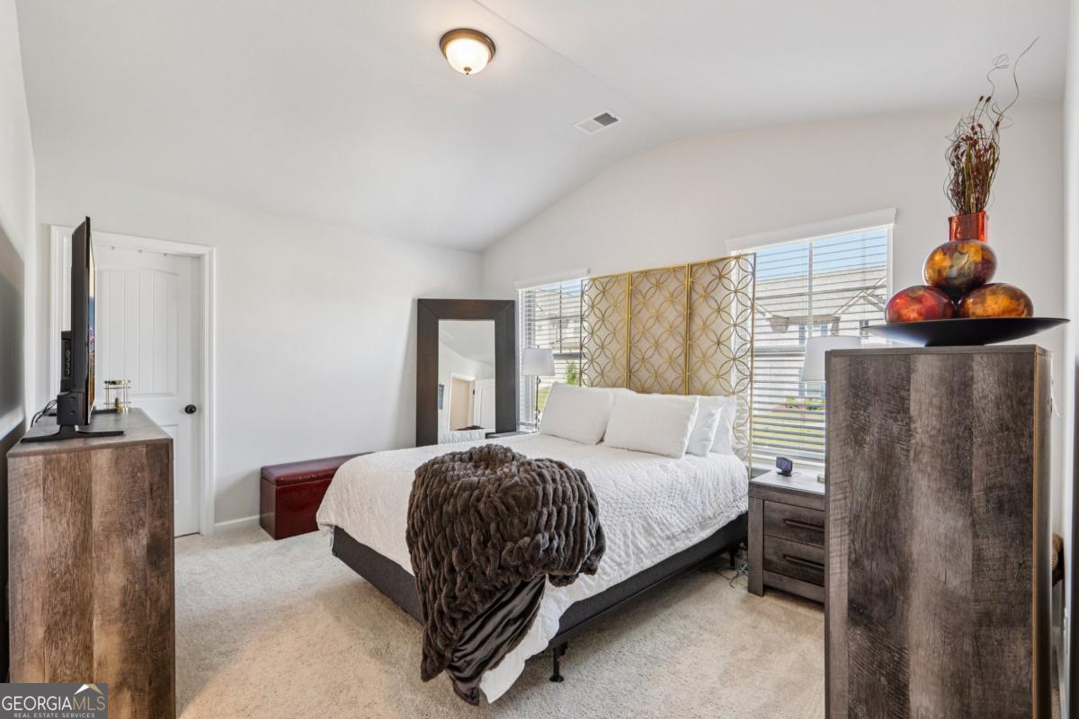 4774 Sultana Way Atlanta, GA 30331 - Photo 14 of 25 a bedroom with a bed and dresser with mirror