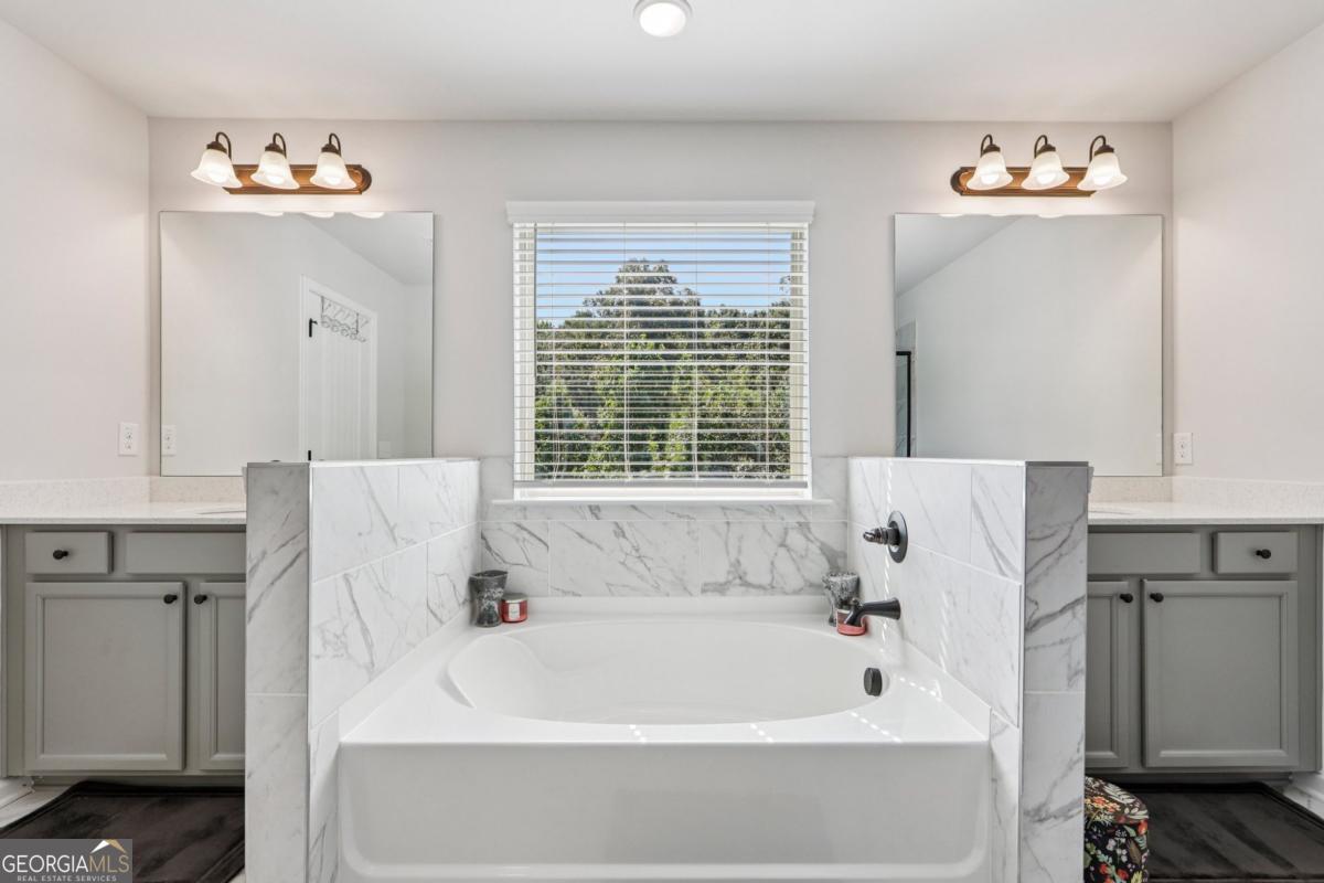 4774 Sultana Way Atlanta, GA 30331 - Photo 22 of 25 a bathroom with a bathtub and a window