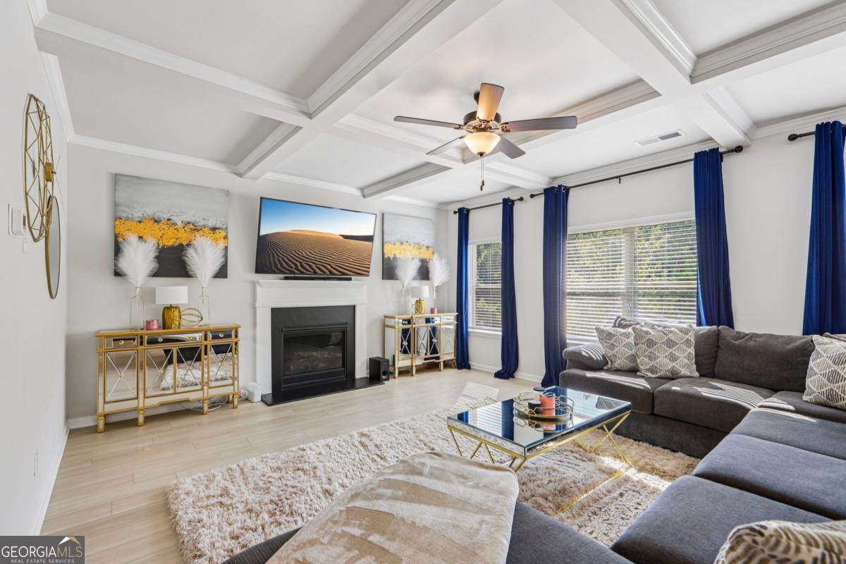 4774 Sultana Way Atlanta, GA 30331 - Photo 6 of 25 a living room with furniture a fireplace and a flat screen tv