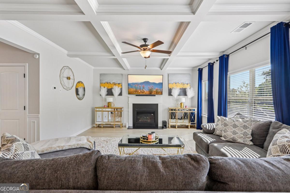 4774 Sultana Way Atlanta, GA 30331 - Photo 7 of 25 a living room with furniture a fireplace and a large window