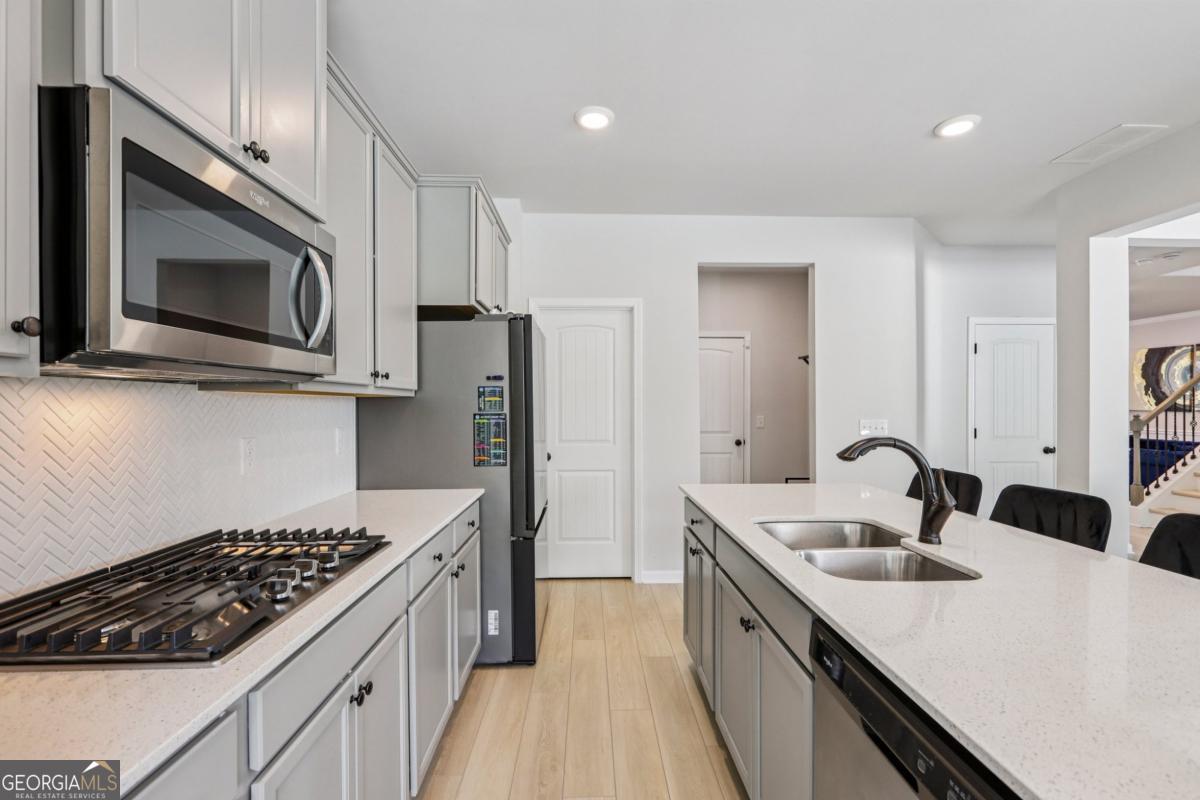 4774 Sultana Way Atlanta, GA 30331 - Photo 9 of 25 a kitchen with a sink stove and microwave