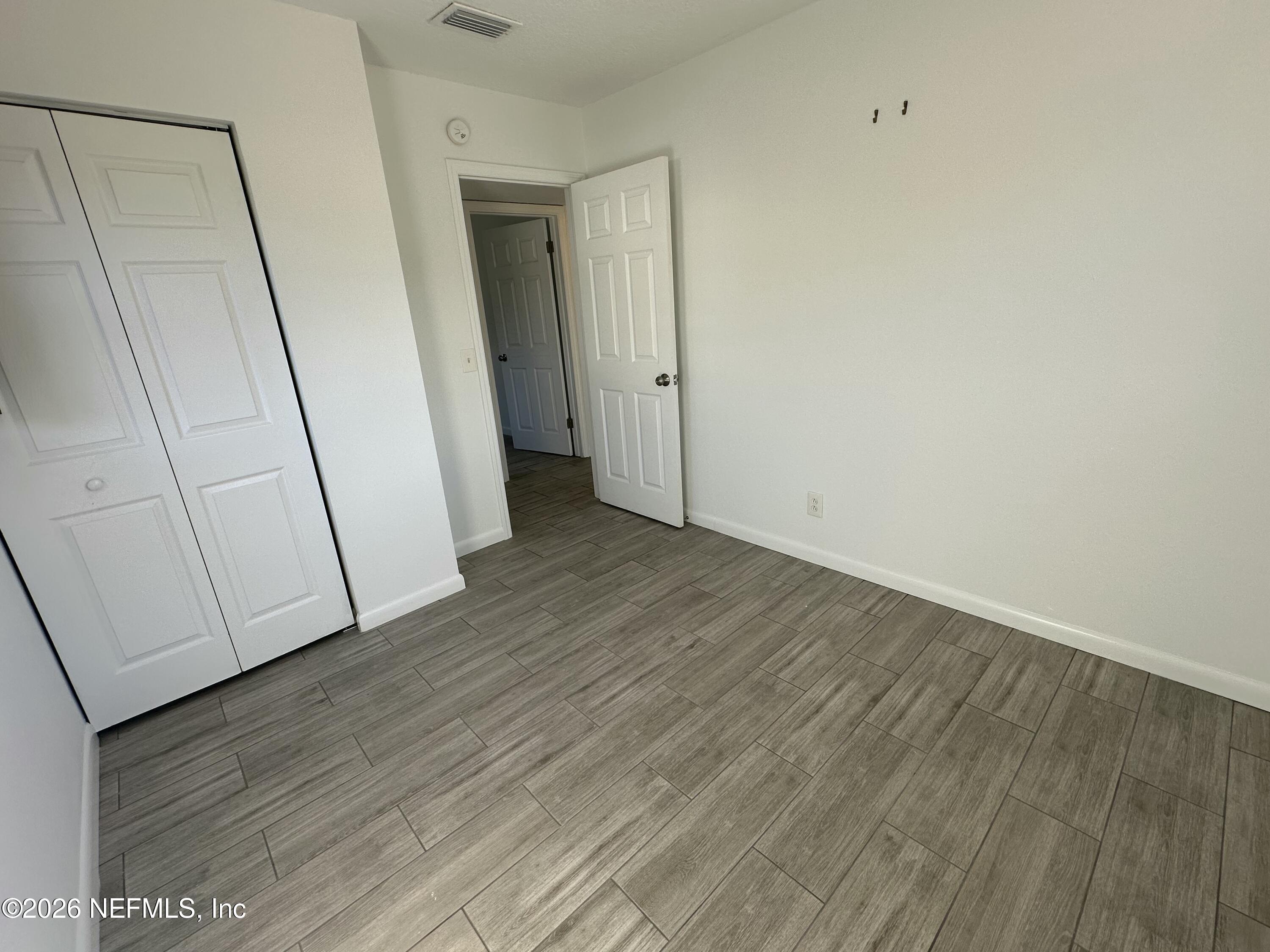 365 Sargo Road Atlantic Beach, FL 32233 - Photo 15 of 23 a view of a hallway with wooden floor