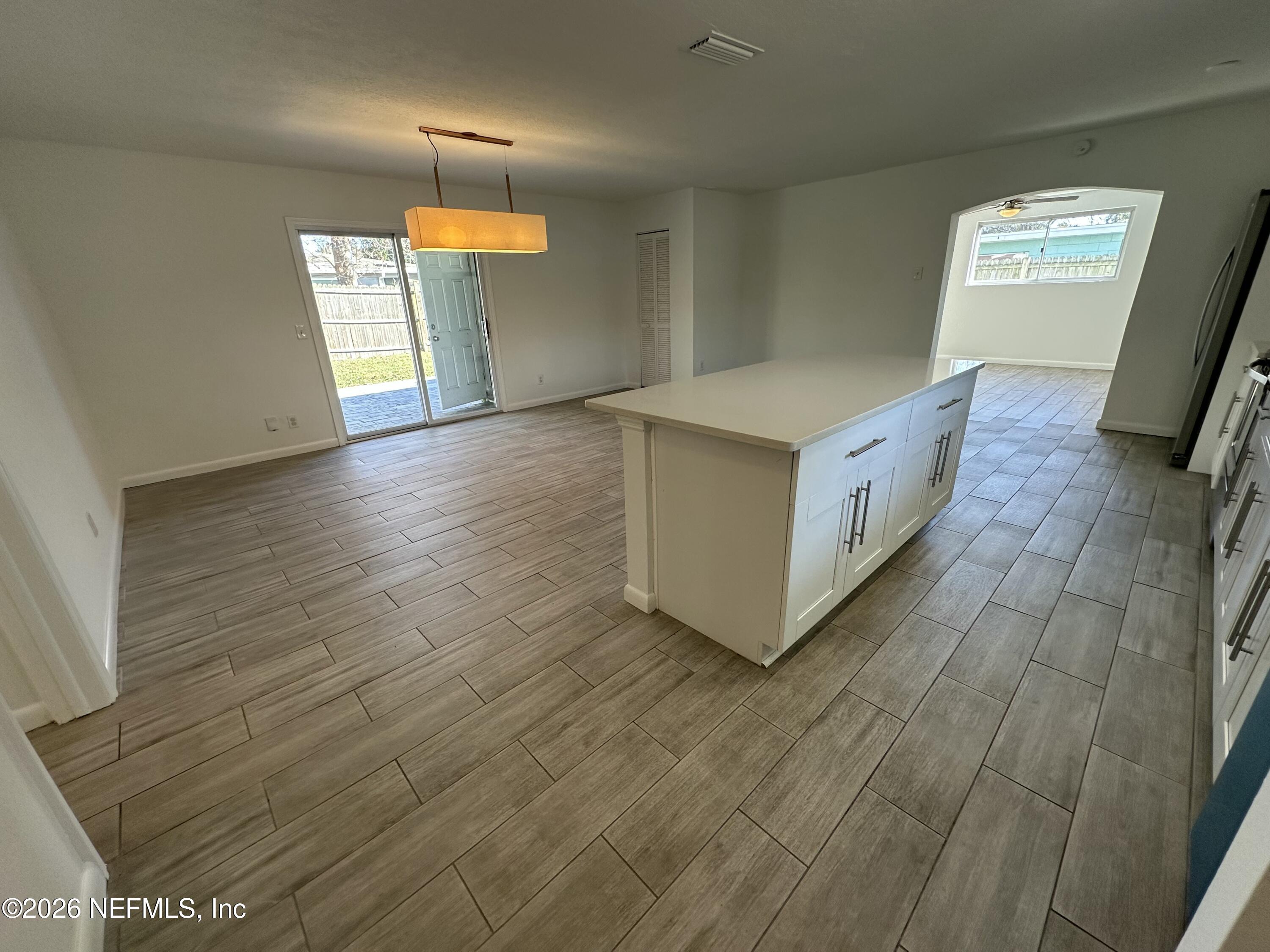 365 Sargo Road Atlantic Beach, FL 32233 - Photo 3 of 23 a view of an empty room with window and wooden floor