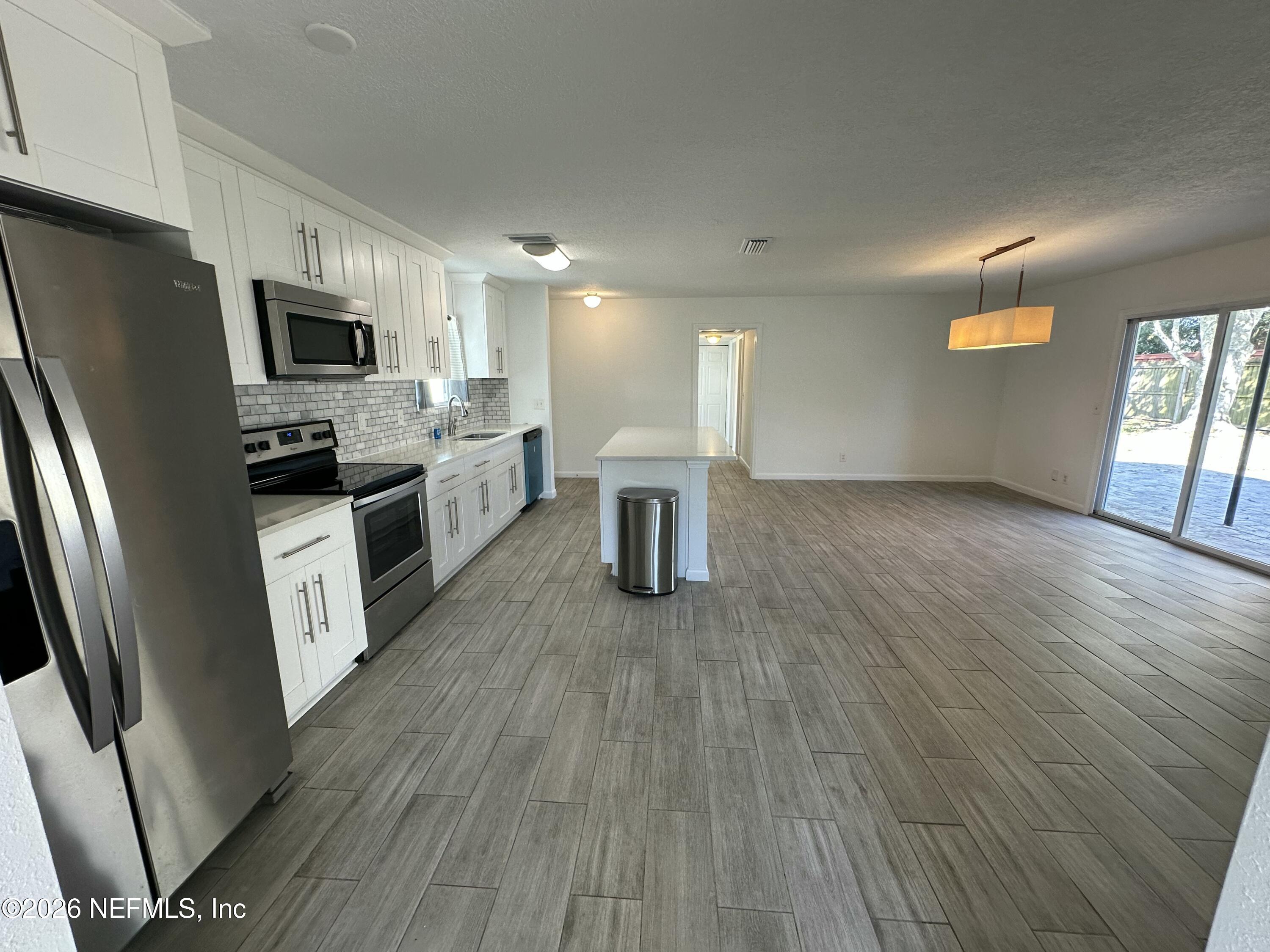 365 Sargo Road Atlantic Beach, FL 32233 - Photo 7 of 23 a kitchen with stainless steel appliances granite countertop a refrigerator a stove top oven a sink and dishwasher