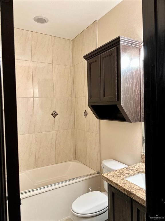 3017 Colorado Avenue McAllen, TX 78504 - Photo 13 of 20 a bathroom with a granite countertop toilet sink and shower