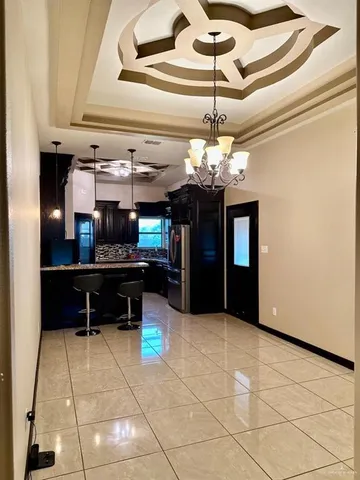 a view of kitchen with furniture and chandelier