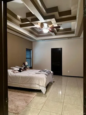 a bedroom with a bed and a ceiling fan