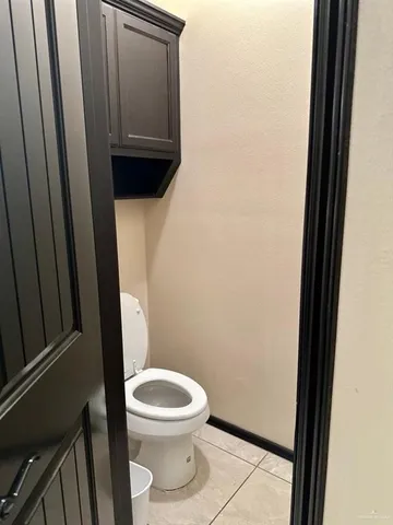 a white toilet sitting next to a sink