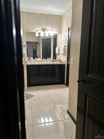 a room with a refrigerator and mirror