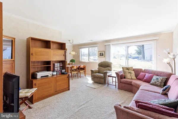 a living room with furniture fireplace and a window