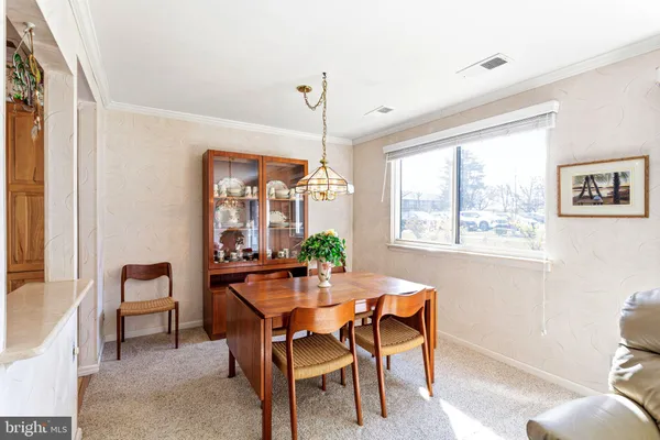 a dining room with furniture a chandelier and wooden floor