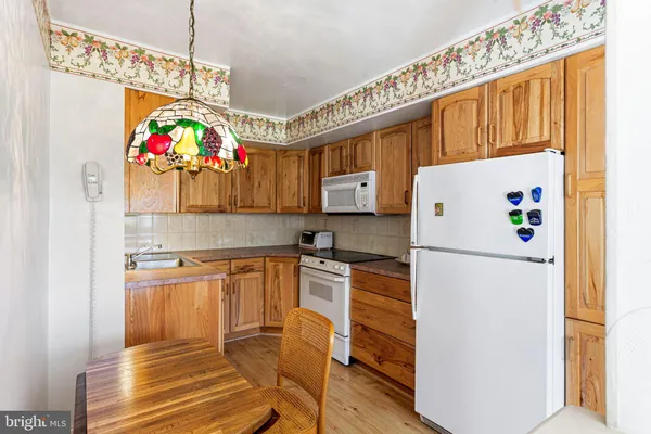 a kitchen with granite countertop a refrigerator and a sink