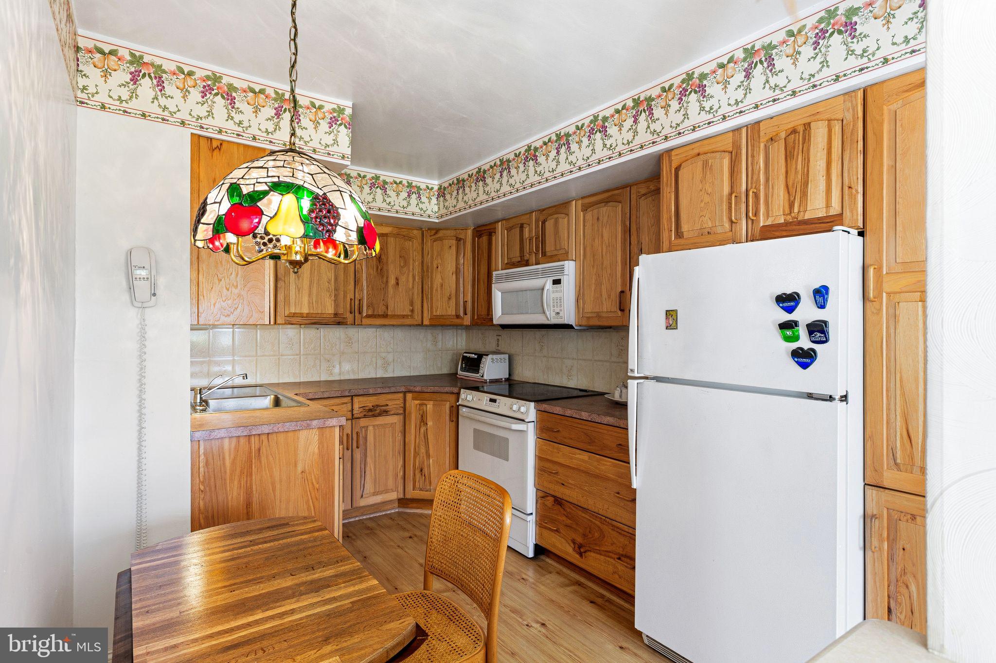 115 East Kings Highway, Unit 271 Maple Shade, NJ 08052 - Photo 7 of 14 a kitchen with granite countertop a refrigerator and a sink