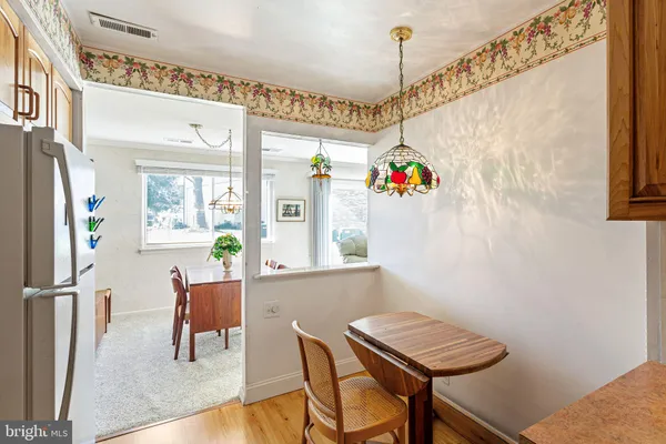 a dining room with furniture and a window