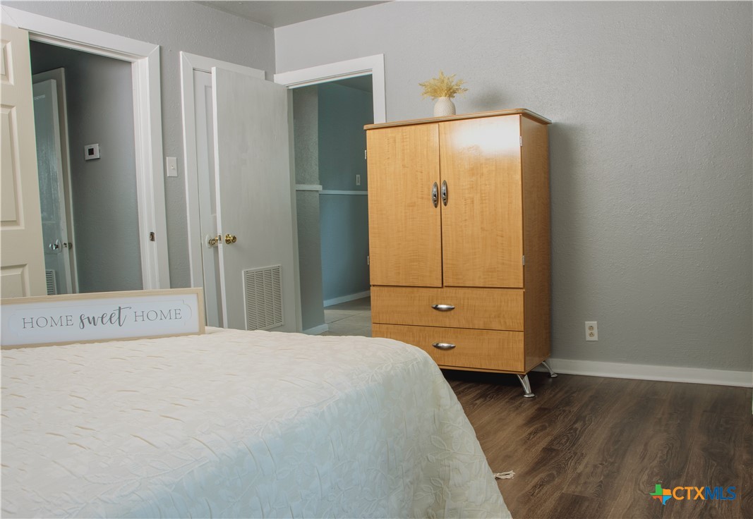 1407 South 7th Street Temple, TX 76504 - Photo 18 of 36 a bedroom with a bed and cabinet