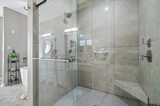 a bathroom with a glass shower door