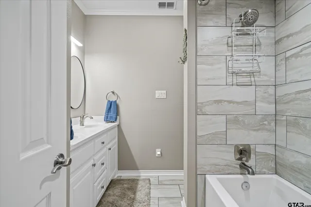 a bathroom with a tub sink and mirror