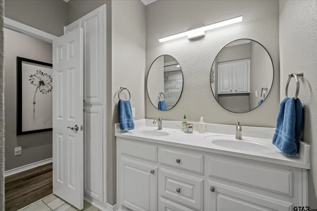 a bathroom with 2 sink and a mirror