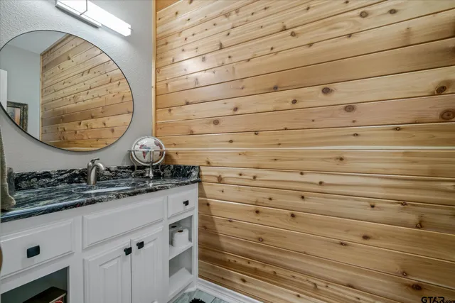 a view of backyard with table and chairs and wooden fence