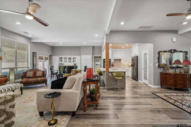 a living room kitchen with furniture and a table