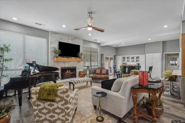 a living room with fireplace furniture and a flat screen tv