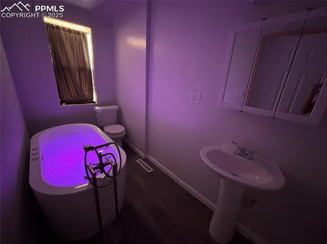 a bathroom with a sink a mirror and a toilet