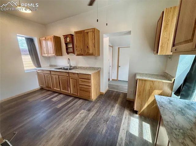 a kitchen with stainless steel appliances granite countertop a sink stove and wooden floor