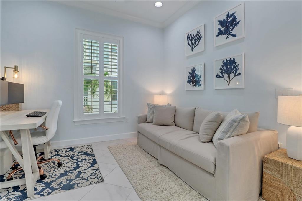 6509 Dominica Drive, Unit 101 Naples, FL 34113 - Photo 19 of 33 a living room with a couch and a window with wooden floor