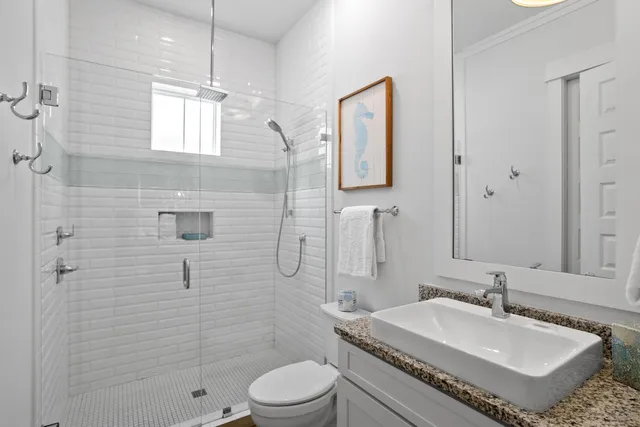 a bathroom with a sink toilet and shower