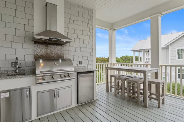 a kitchen with a stove a sink and cabinets