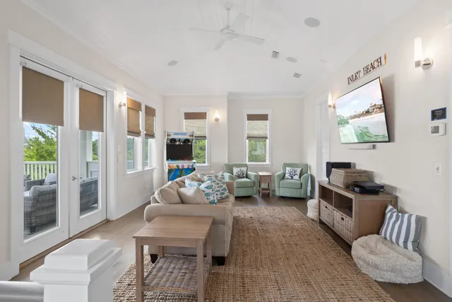 a living room with furniture and a floor to ceiling window