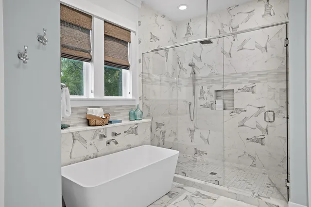 a bathroom with a tub a sink and a shower
