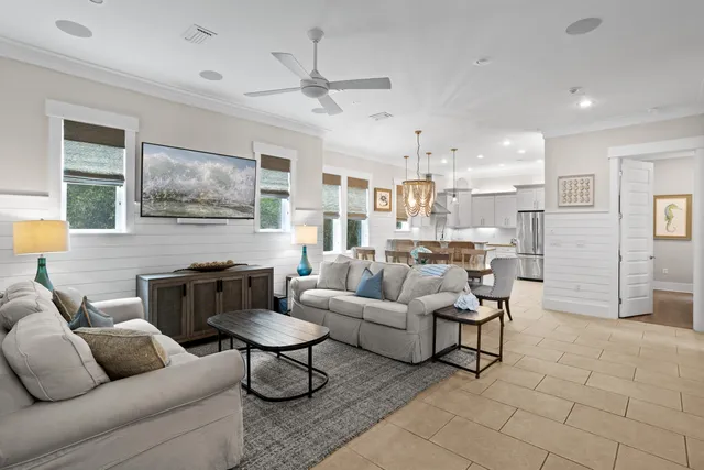 a living room with furniture and kitchen view