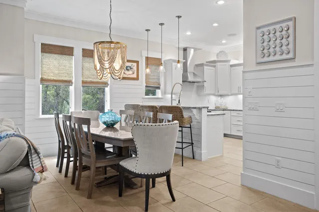 a dining table chairs and a chandelier