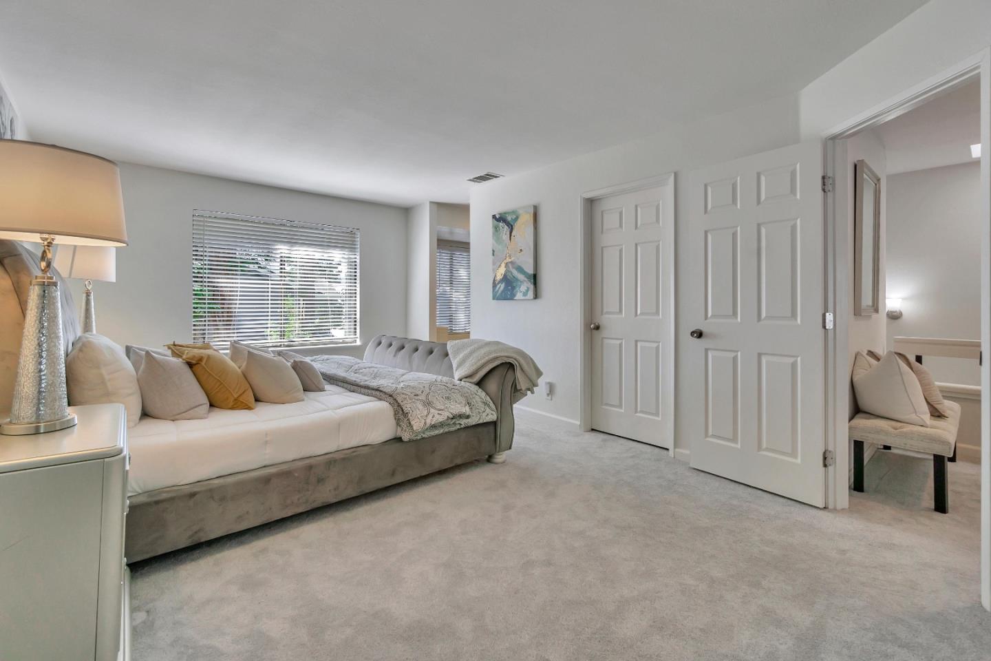 1677 Geary Road Walnut Creek, CA 94597 - Photo 12 of 38 a spacious bedroom with a bed and a couch