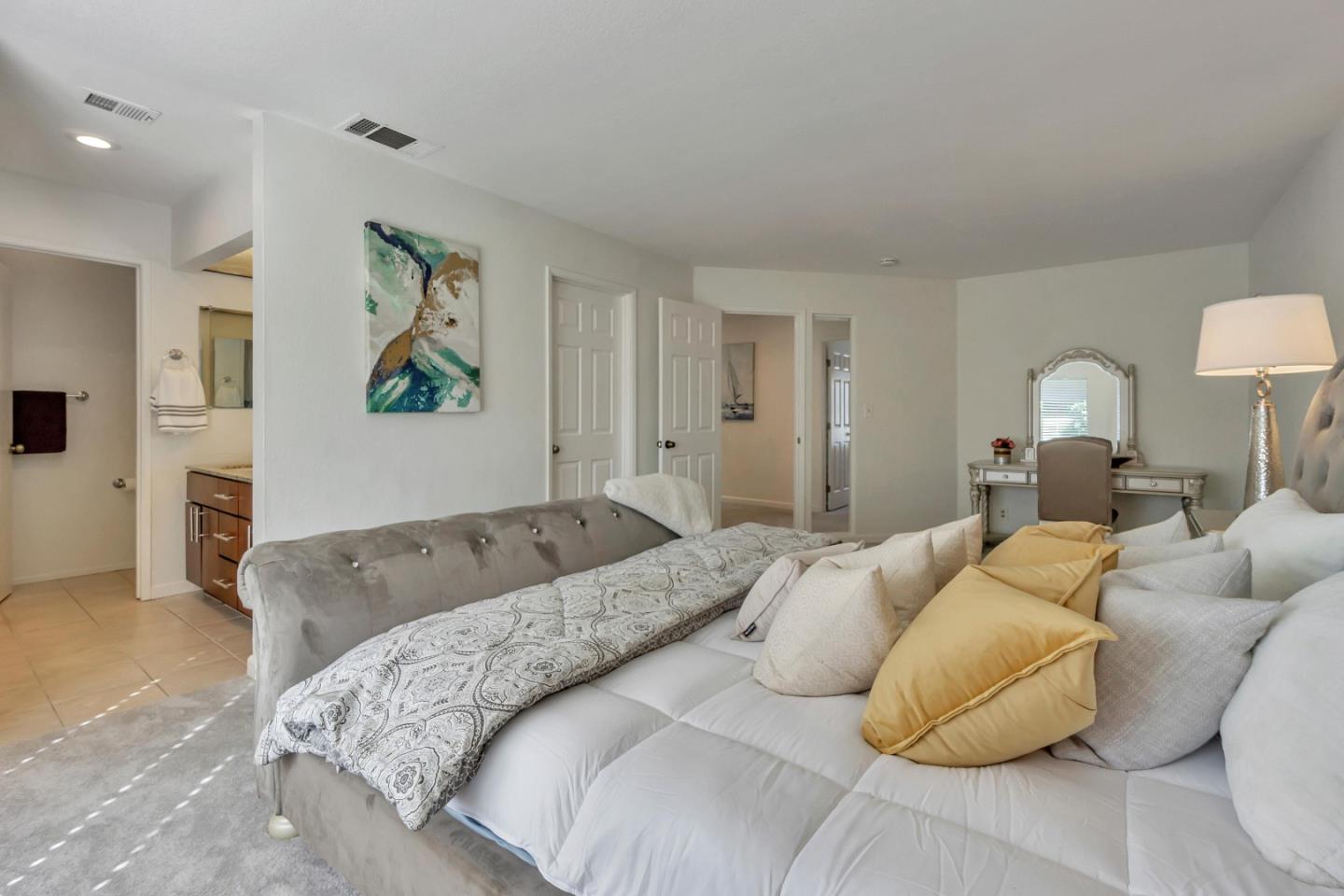 1677 Geary Road Walnut Creek, CA 94597 - Photo 14 of 38 a bedroom with a bed and painting on the wall