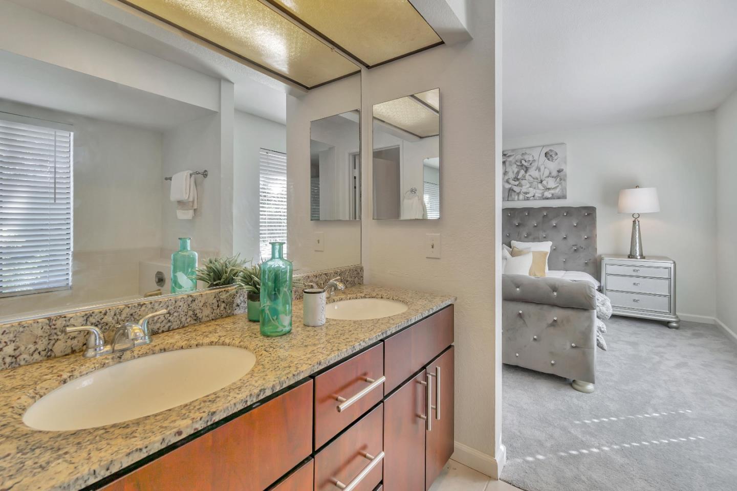 1677 Geary Road Walnut Creek, CA 94597 - Photo 15 of 38 a en suite bathroom with a granite countertop double vanity sink and a mirror