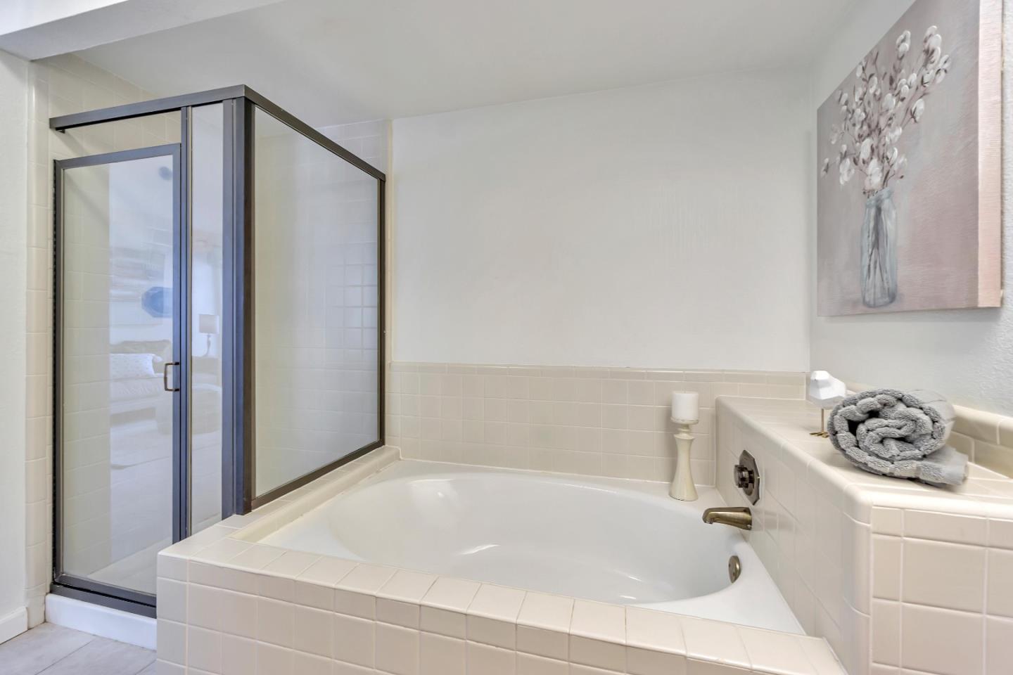 1677 Geary Road Walnut Creek, CA 94597 - Photo 23 of 38 a bathroom with a bathtub and shower