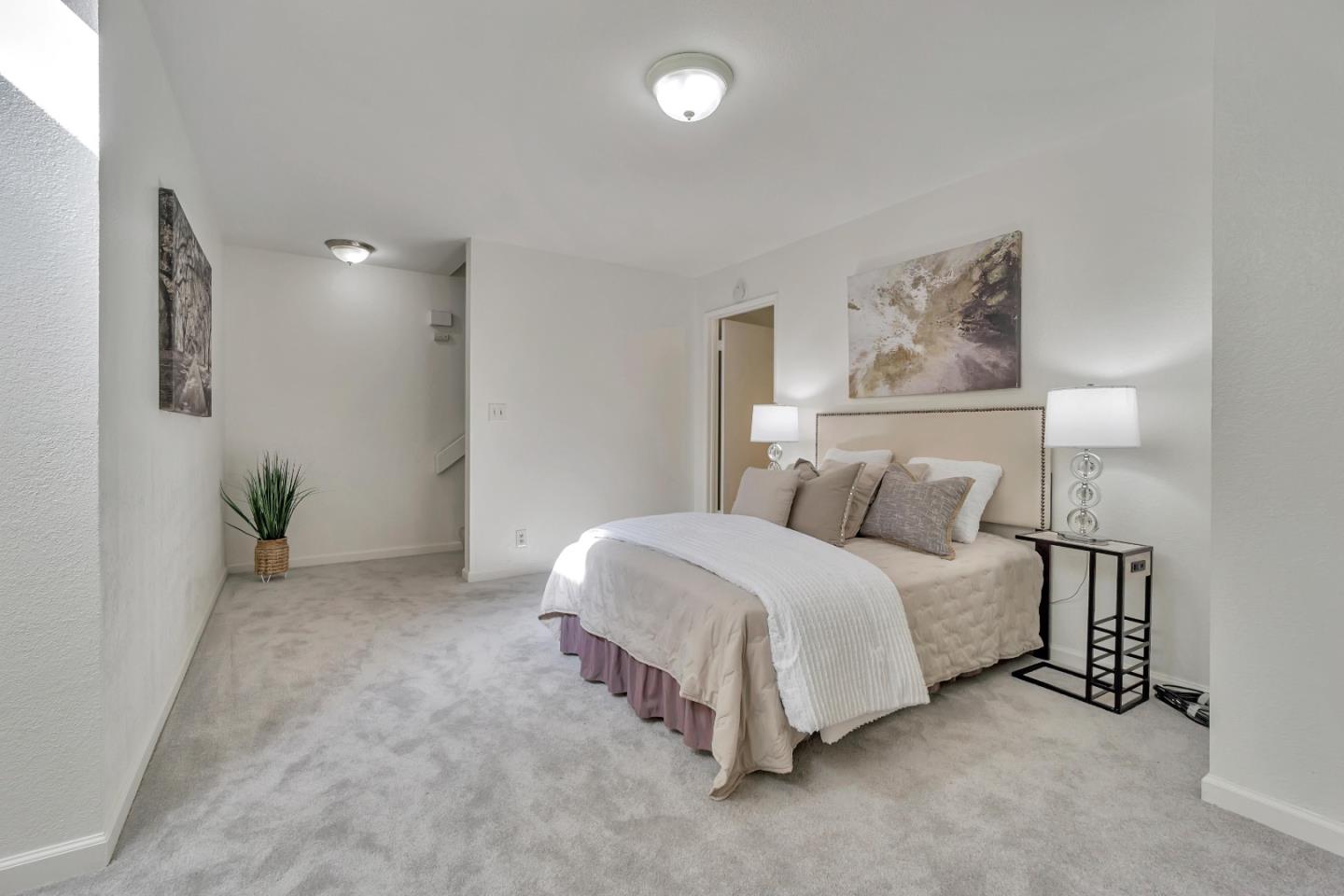 1677 Geary Road Walnut Creek, CA 94597 - Photo 27 of 38 a spacious bedroom with a bed and painting on the wall