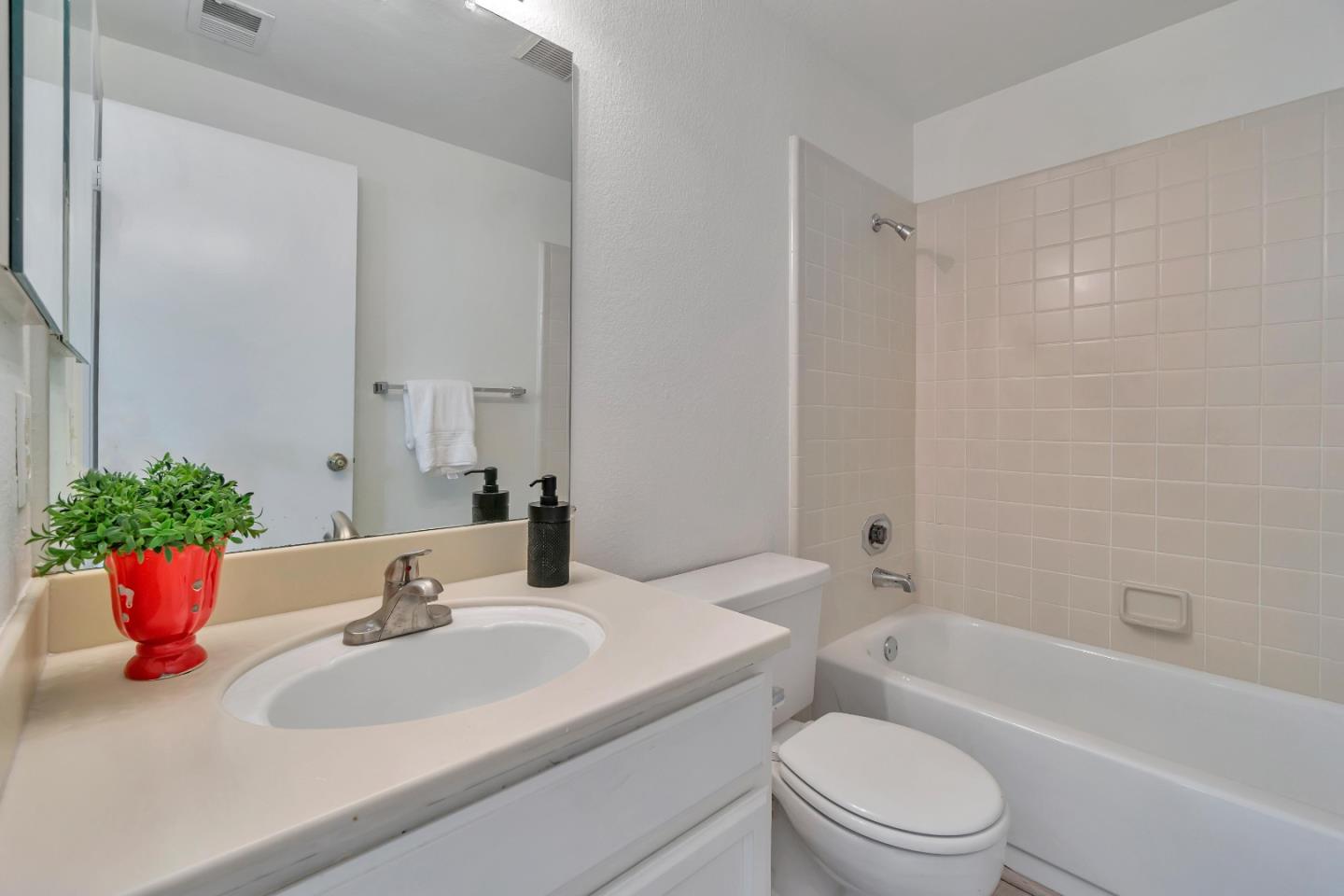 1677 Geary Road Walnut Creek, CA 94597 - Photo 28 of 38 a bathroom with a sink a toilet and shower