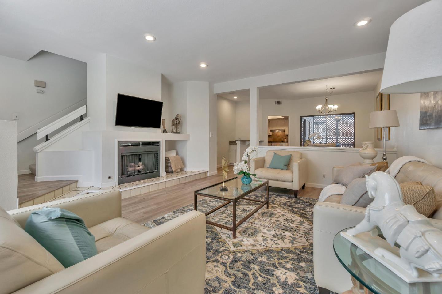 1677 Geary Road Walnut Creek, CA 94597 - Photo 3 of 38 a living room with furniture a flat screen tv and a fireplace