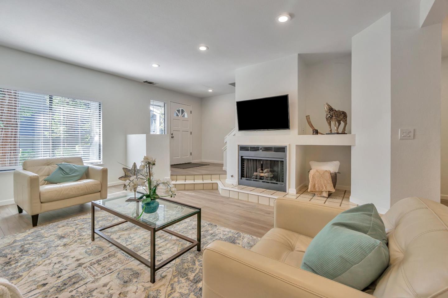 1677 Geary Road Walnut Creek, CA 94597 - Photo 4 of 38 a living room with furniture a fireplace and a flat screen tv