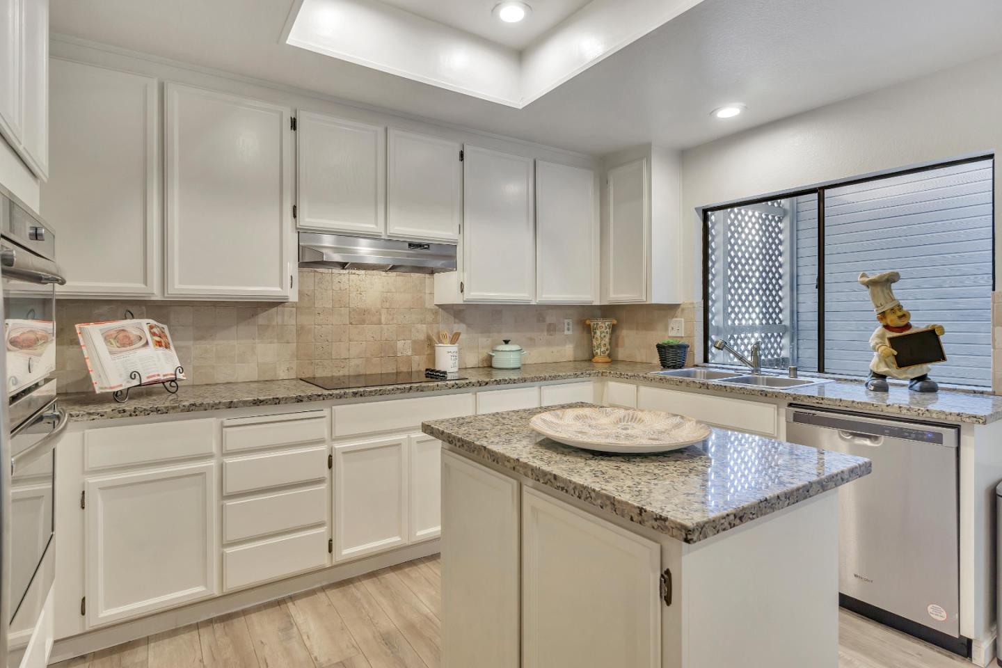 1677 Geary Road Walnut Creek, CA 94597 - Photo 5 of 38 a kitchen with granite countertop kitchen island a sink stainless steel appliances and cabinets