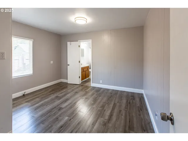 a view of an empty room and wooden floor