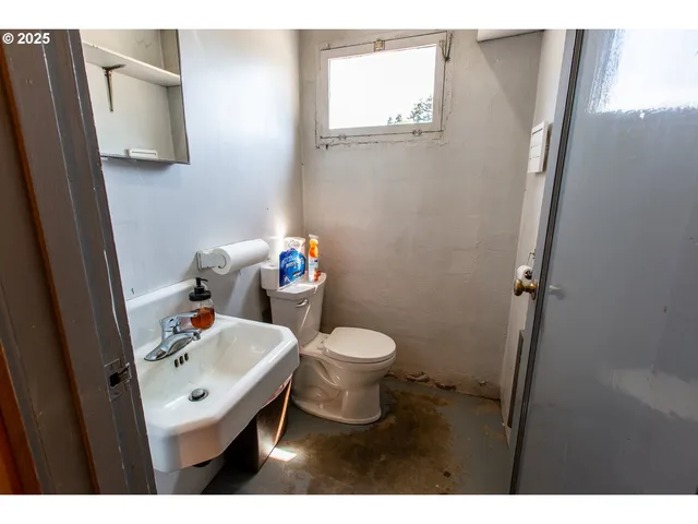 a bathroom with a sink toilet and a mirror